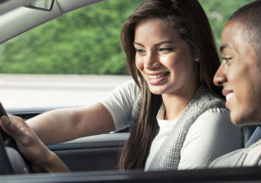 A woman giving tips to a Gilbert driver